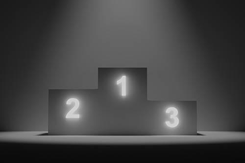 Photo of an award stand with places for 1, 2, and 3.